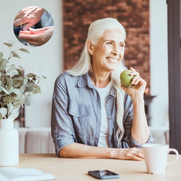 Denture repair and relines in Guelph – woman eating an apple comfortably with her repaired denture